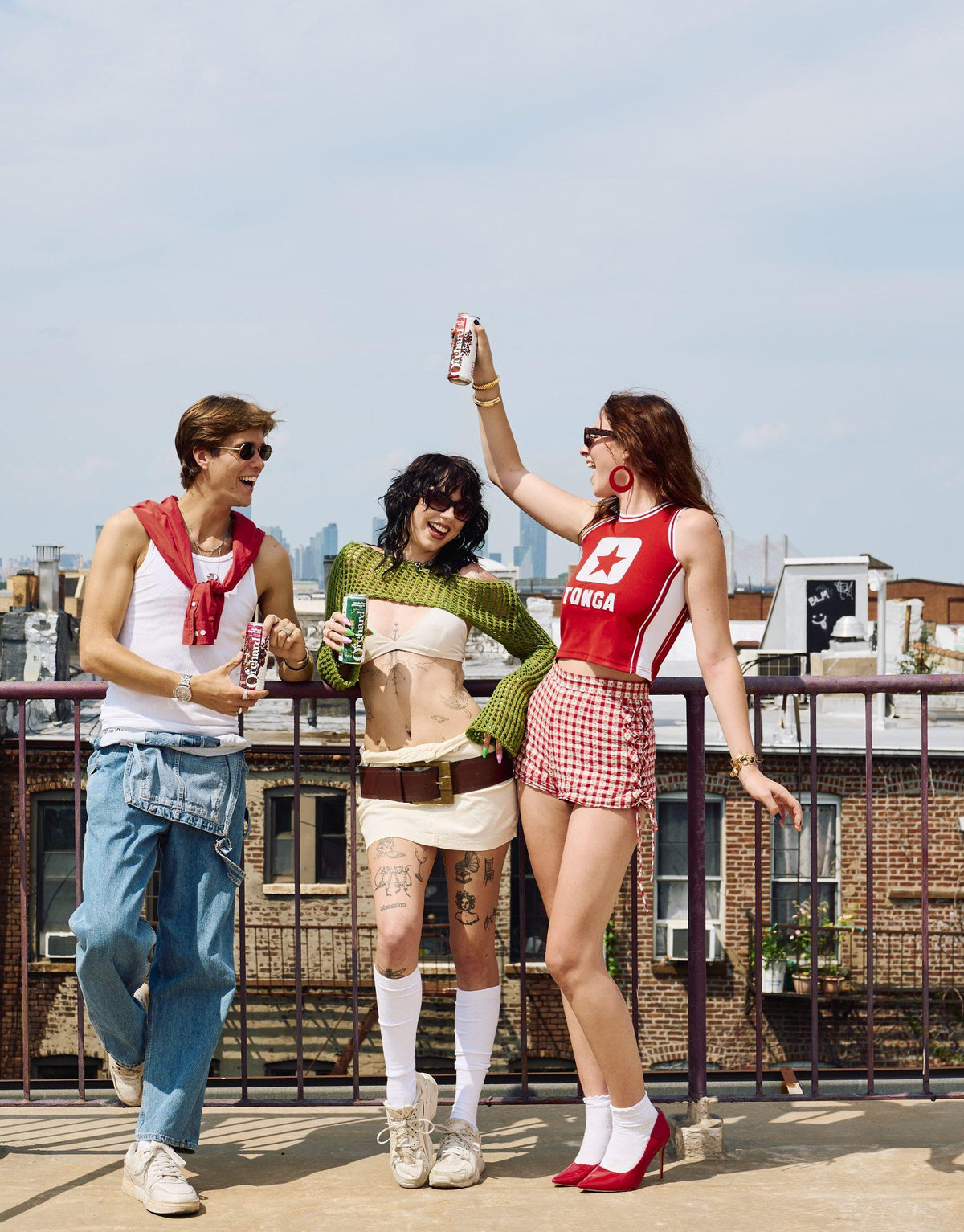 three friends on a rooftop with Orchard cans